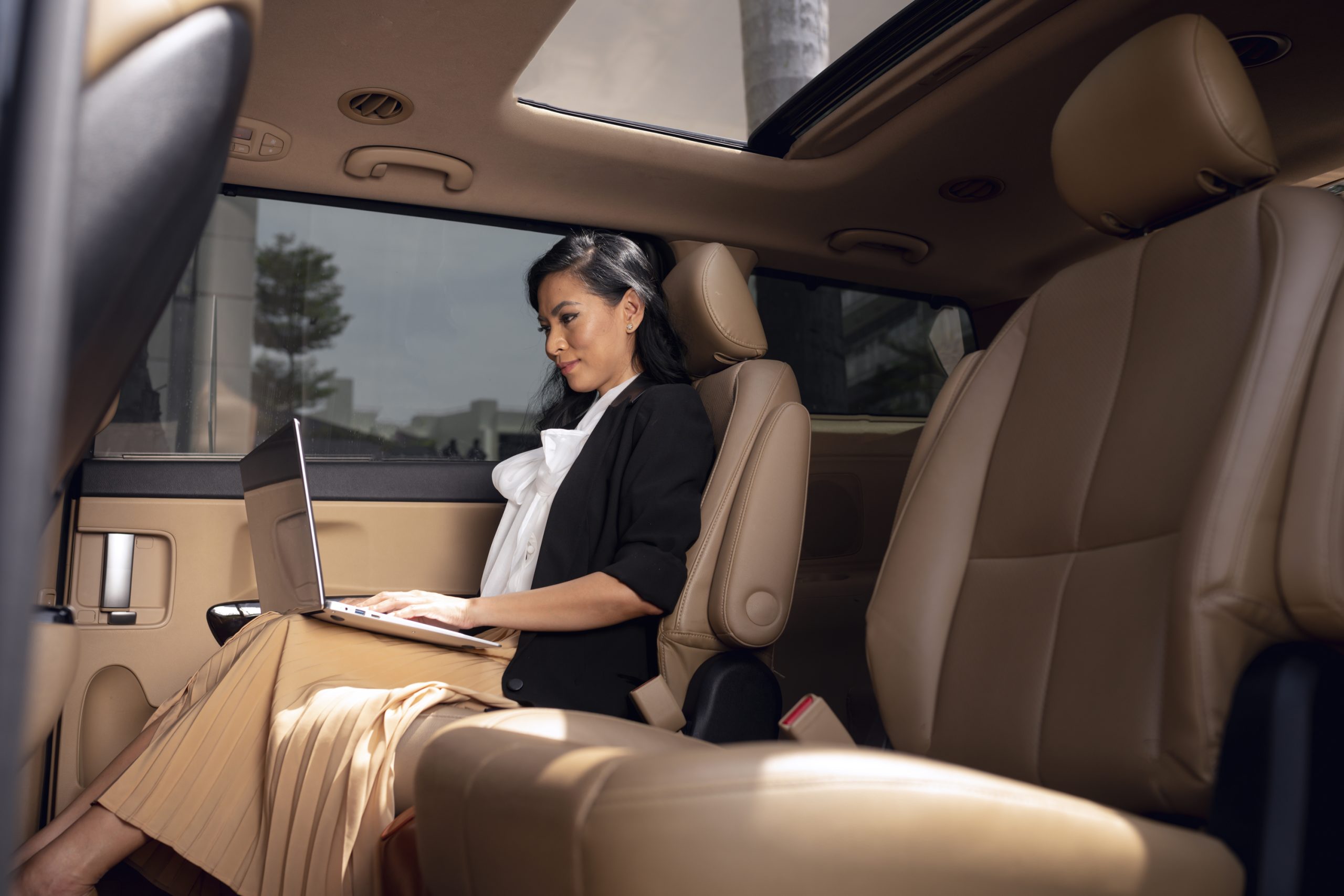 businesswoman sitting backseat taxi scaled